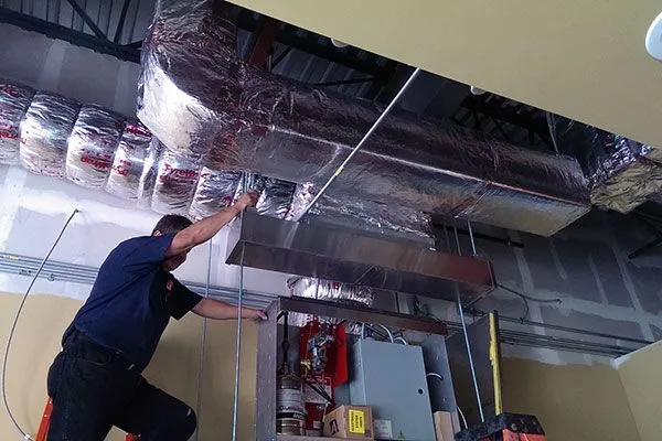Commercial HVAC Tech Performing A Ductwork Installation
